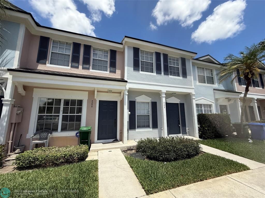 5295 Jamboree Place Margate, FL 33063 - Photo 3 of 35 front view of a brick house with a yard
