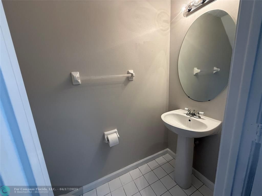 5295 Jamboree Place Margate, FL 33063 - Photo 6 of 35 a bathroom with a sink and mirror