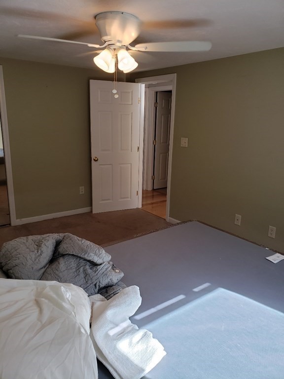4 Tideview Path, Unit 11 Plymouth, MA 02360 - Photo 11 of 15 a bedroom with a bed and a chandelier