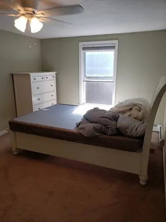 a bedroom with a bed and a window