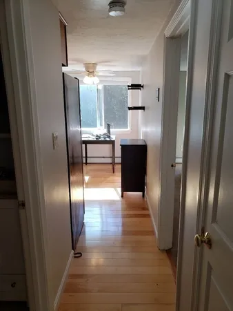 a kitchen with granite countertop stainless steel appliances a refrigerator and cabinets