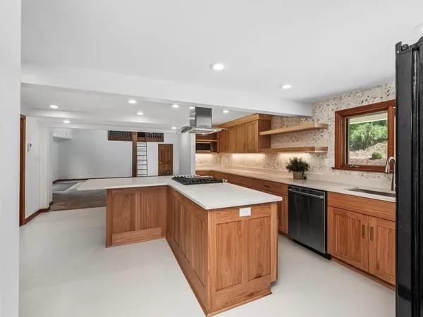 a kitchen with stainless steel appliances granite countertop a sink and a stove