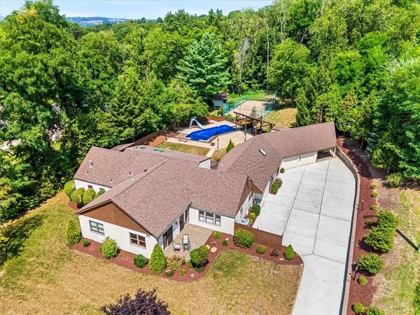 an aerial view of a house with yard patio and outdoor seating