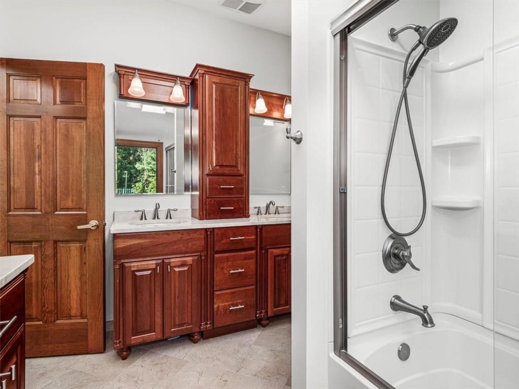 2350 Morrow Road Pittsburgh, PA 15241 - Photo 30 of 49 a bathroom with a granite countertop sink a mirror and a shower