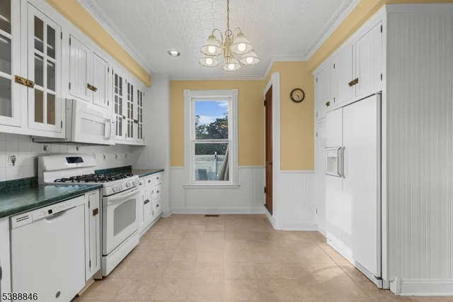 an empty room with windows and cabinet