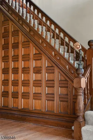 an empty room with wooden floor closet and windows