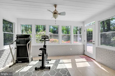 a room with patio furniture and a fireplace