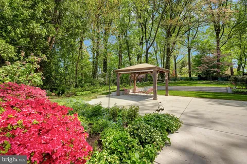 a view of a patio with a table and chairs under an umbrella