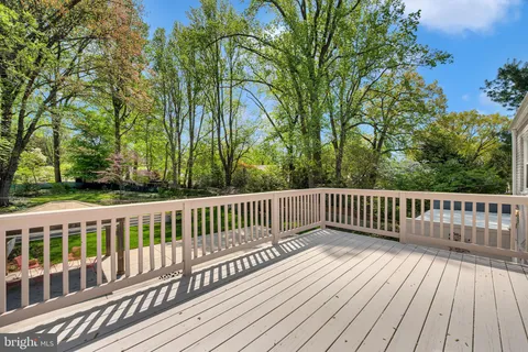 a view of balcony with wooden floor and fence