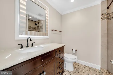 a bathroom with a sink a toilet and a mirror