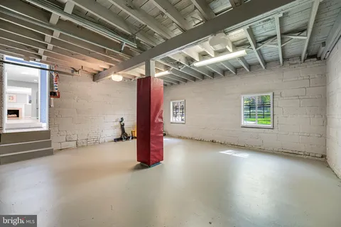 a view of a room with wooden floor and windows