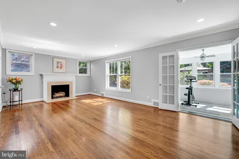 a view of a livingroom with wooden floor and a fireplace