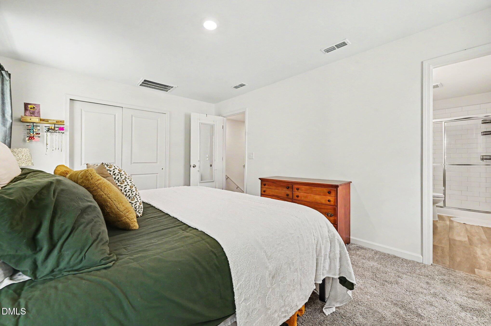 574 Hacksaw Trail Raleigh, NC 27610 - Photo 13 of 28 a bedroom with a bed and a walk in closet