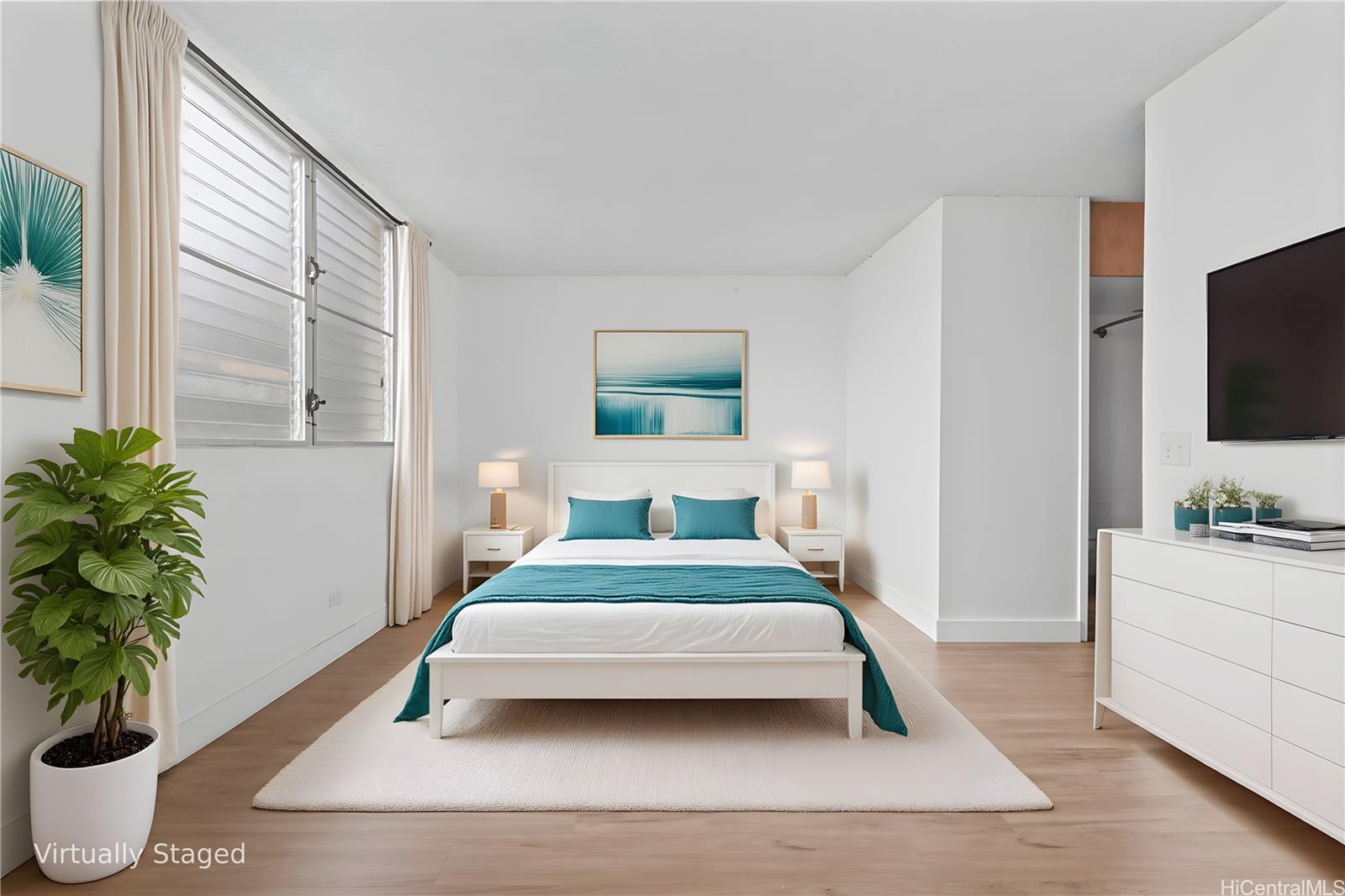 1018 Lunalilo Street, Unit 603 Honolulu, HI 96822 - Photo 3 of 12 a bedroom with a large bed and a flat screen tv