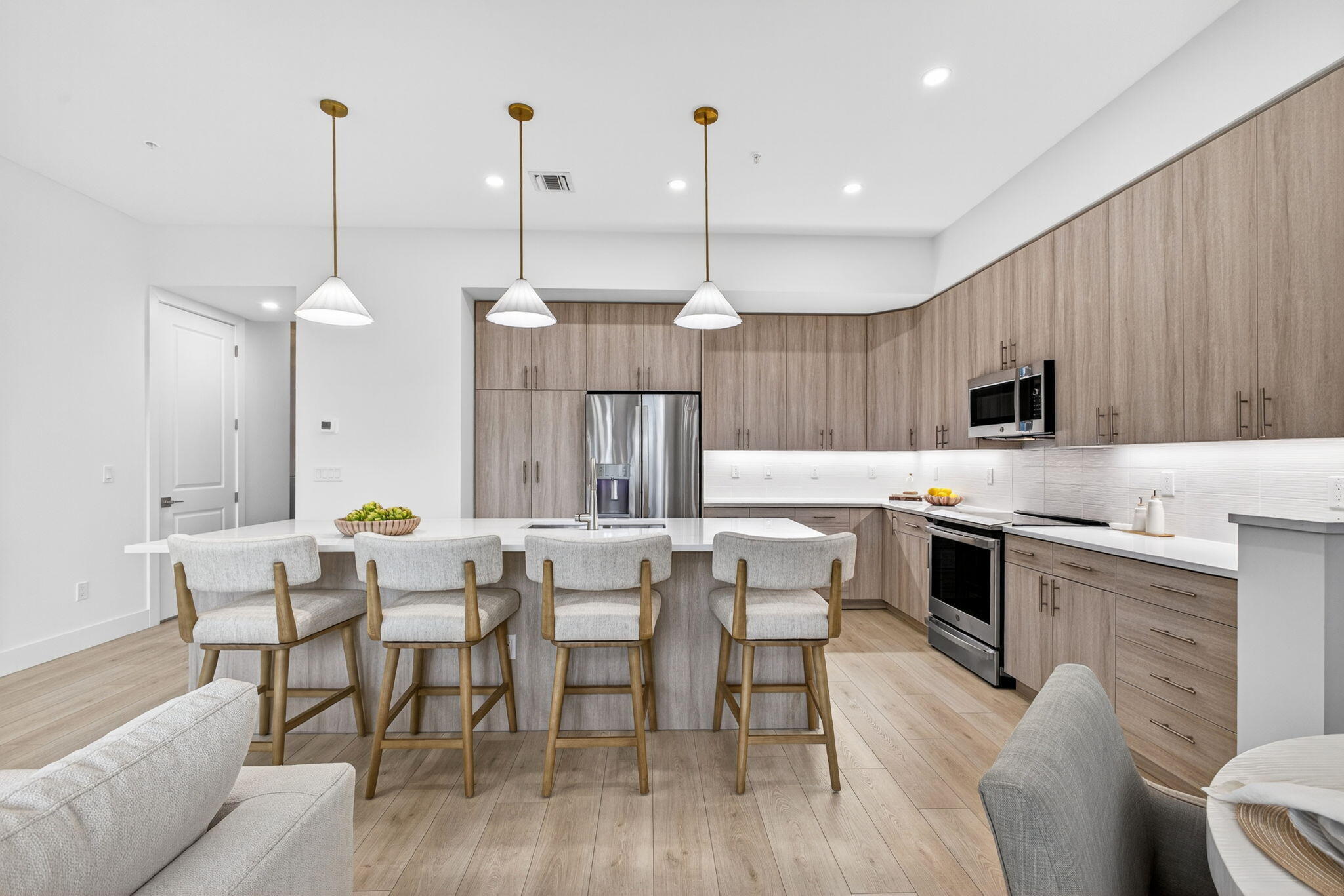 135 Water Pointe Place, Unit 22 Jupiter, FL 33477 - Photo 15 of 55 a kitchen with stainless steel appliances kitchen island granite countertop a dining table chairs and a refrigerator