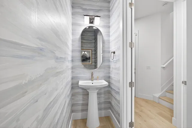 a bathroom with a sink a toilet a mirror and vanity