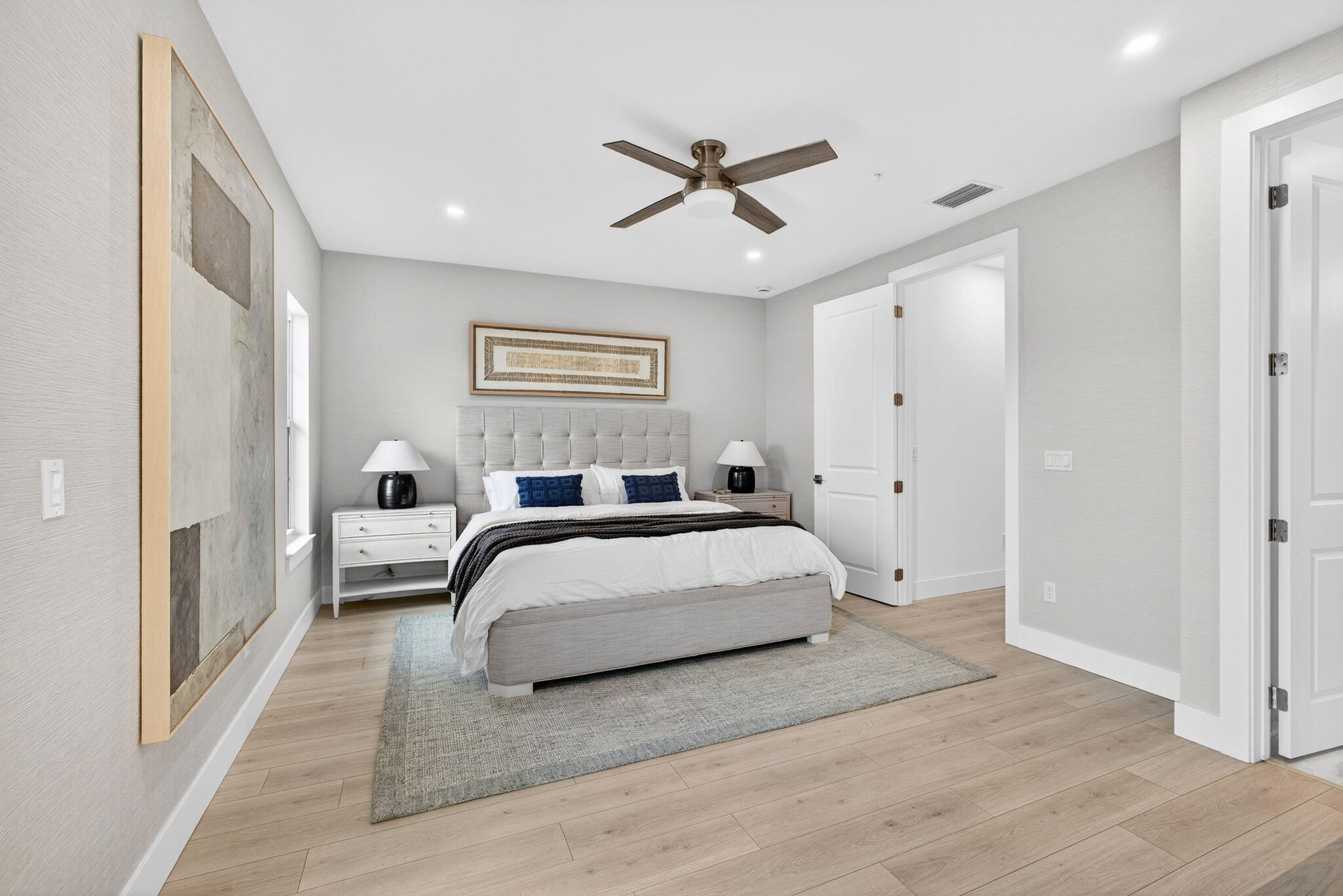 135 Water Pointe Place, Unit 22 Jupiter, FL 33477 - Photo 21 of 55 a spacious bedroom with a bed and a ceiling fan