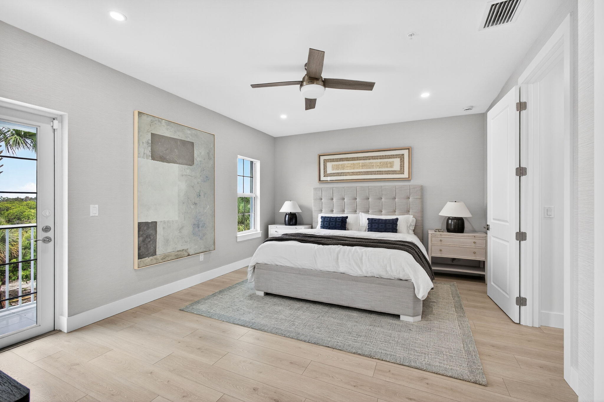 135 Water Pointe Place, Unit 22 Jupiter, FL 33477 - Photo 22 of 55 a spacious bedroom with a large bed and a chandelier