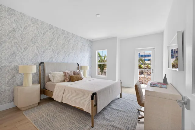 a bedroom with a bed a mirror and a window