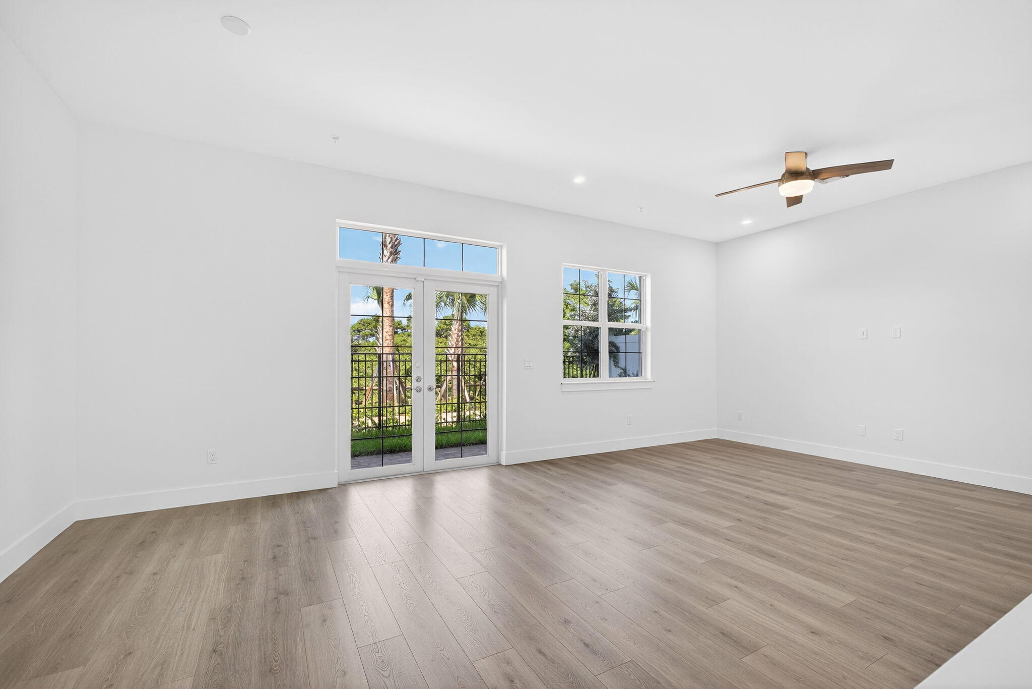 135 Water Pointe Place, Unit 22 Jupiter, FL 33477 - Photo 47 of 55 an empty room with wooden floor and windows