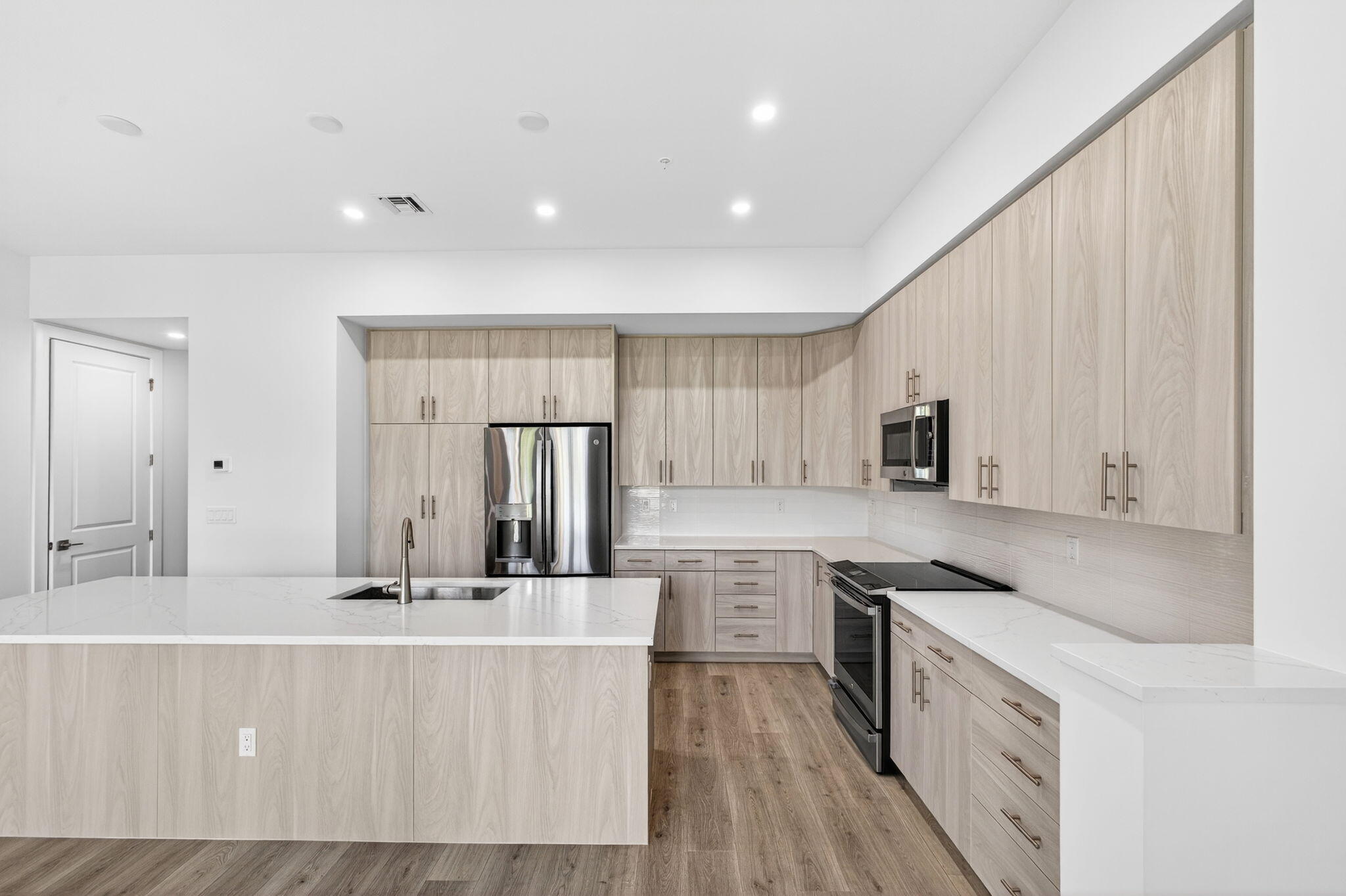 135 Water Pointe Place, Unit 22 Jupiter, FL 33477 - Photo 48 of 55 a large kitchen with stainless steel appliances kitchen island granite countertop a sink and cabinets
