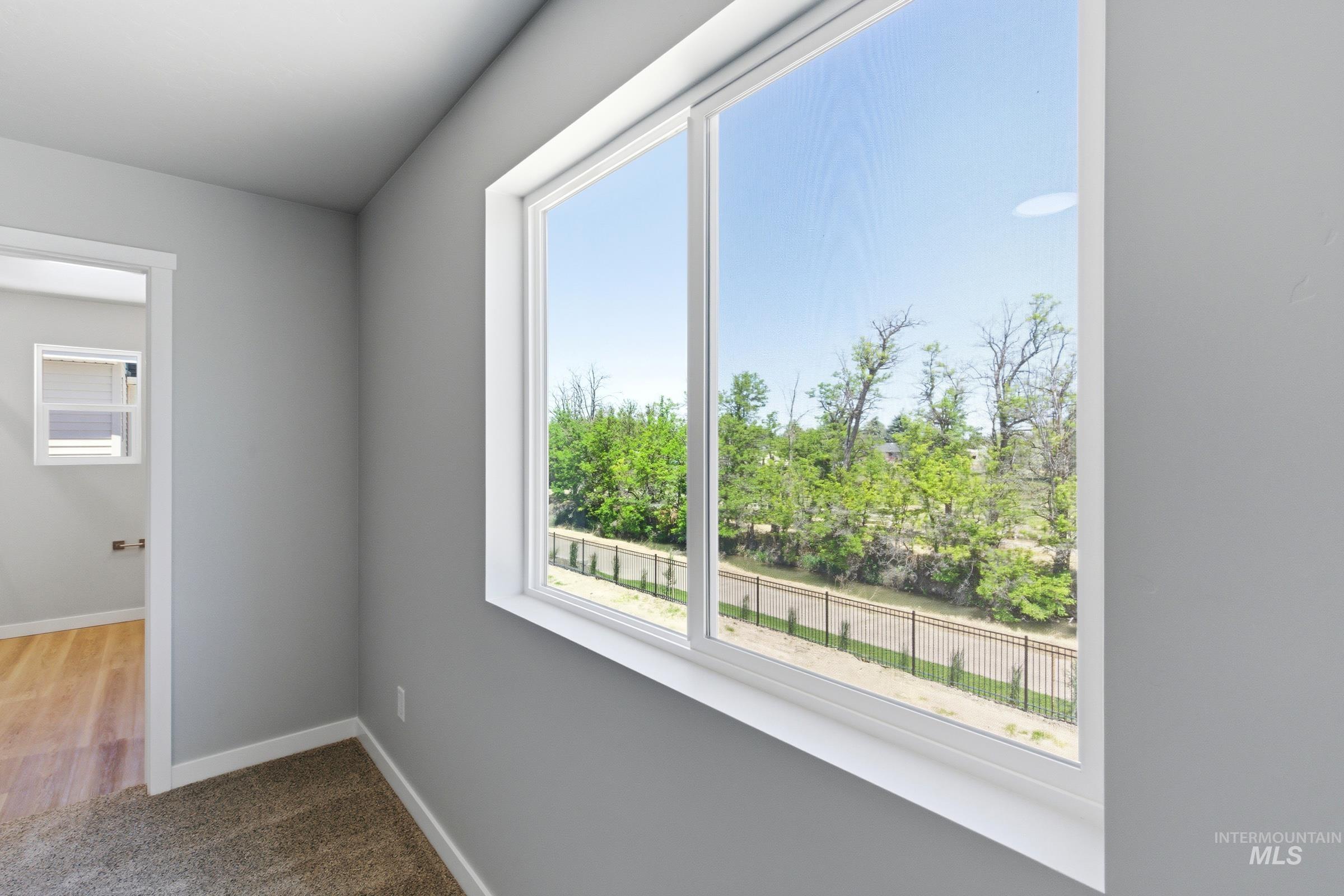 2374 West Fallon Loop Nampa, ID 83651 - Photo 21 of 24 Framed window offering a prominent outdoor perspective of mature trees and a perimeter fence