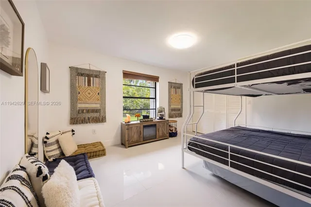 a spacious bedroom with a bed and a couch