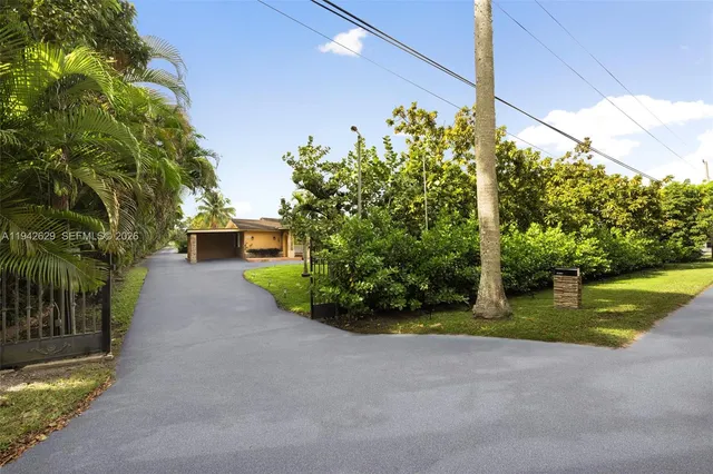 a front view of a house with a yard and a garage