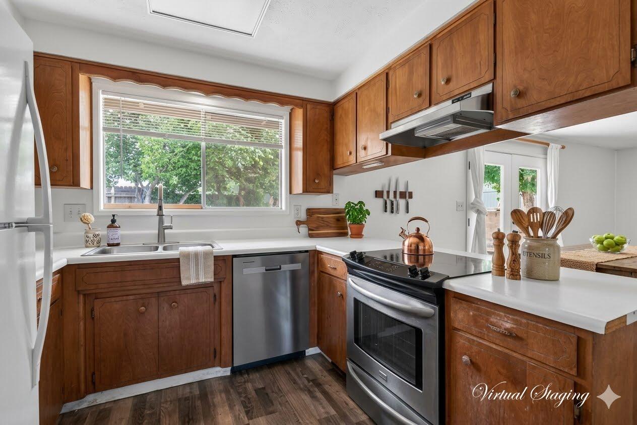 415 Sutter Avenue Medford, OR 97504 - Photo 7 of 28 a kitchen with granite countertop a sink a stove and cabinets