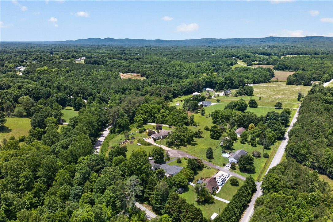 103 Dorsey Lane Walhalla, SC 29691 - Photo 40 of 42 Vast green landscapes surround scattered residences, creating a tranquil rural setting.