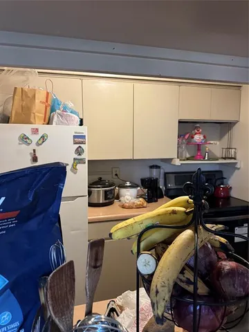 a kitchen with a refrigerator and a stove