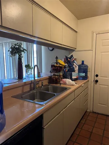 a room with a chair and a chandelier