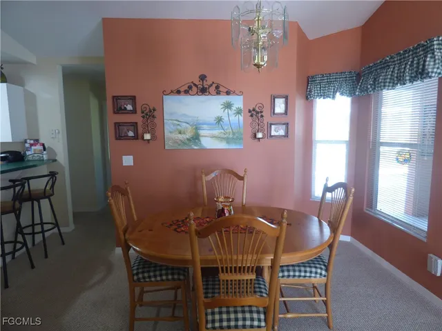 a view of a dining room with furniture and chandelier