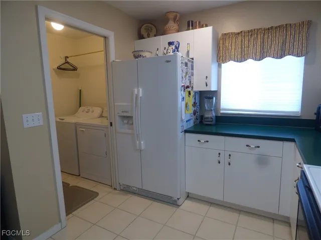 a kitchen with a refrigerator and window