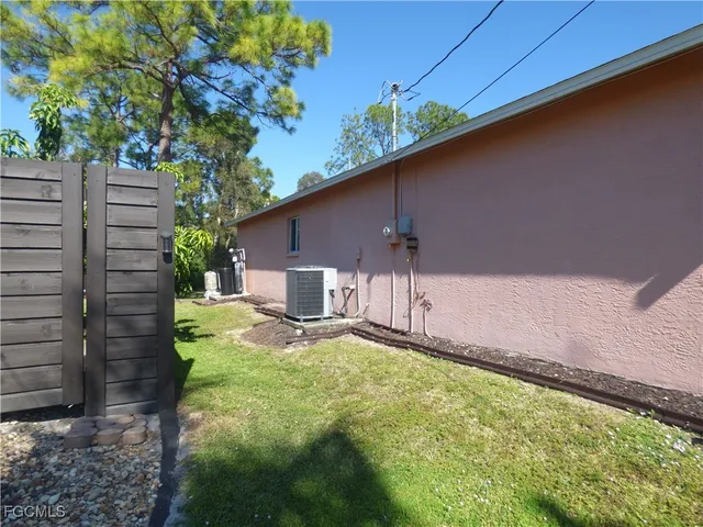 a backyard of a house with table and chairs