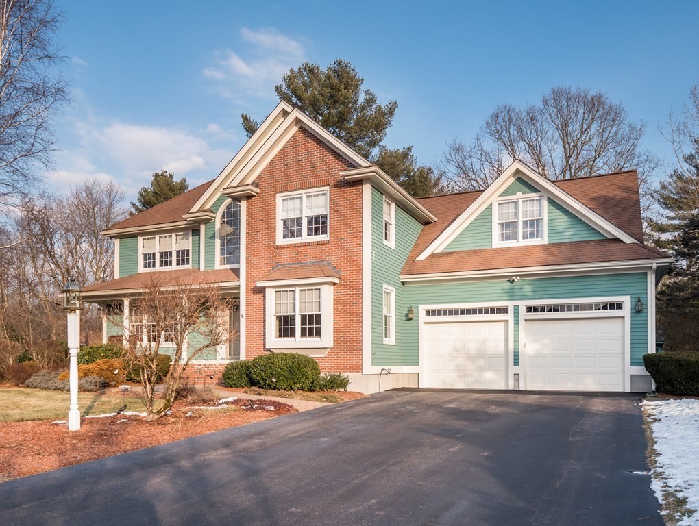 a view of a house with a yard and large tree