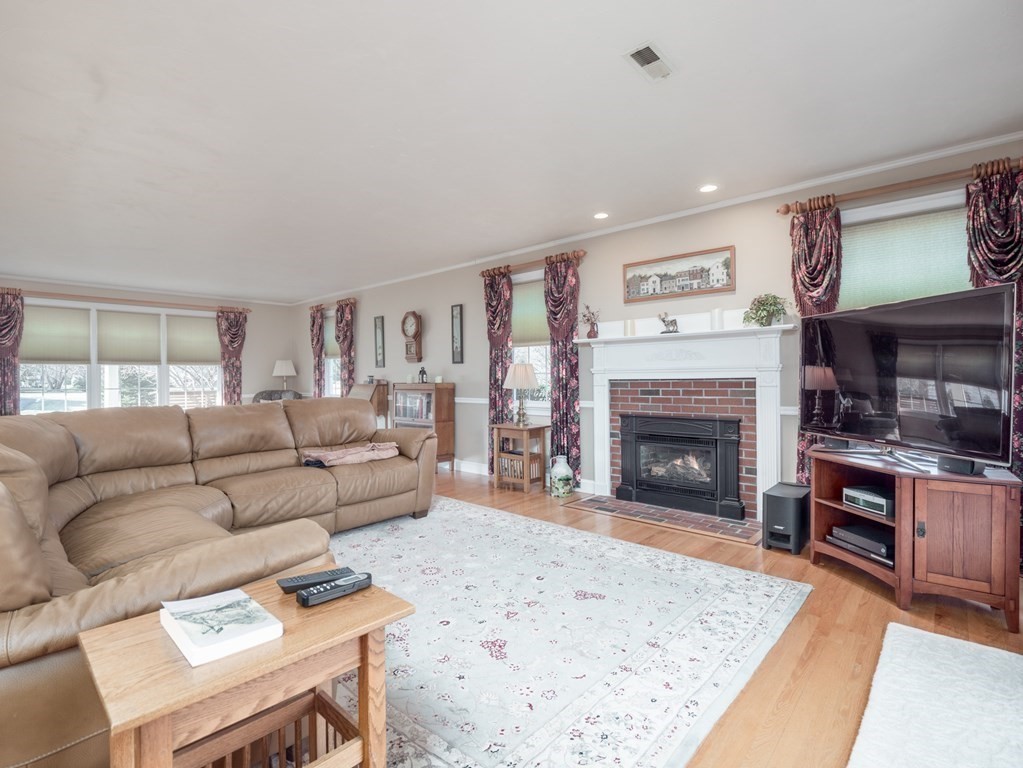 14 Talbott Farm Drive Mendon, MA 01756 - Photo 12 of 40 a living room with furniture a fireplace and a flat screen tv