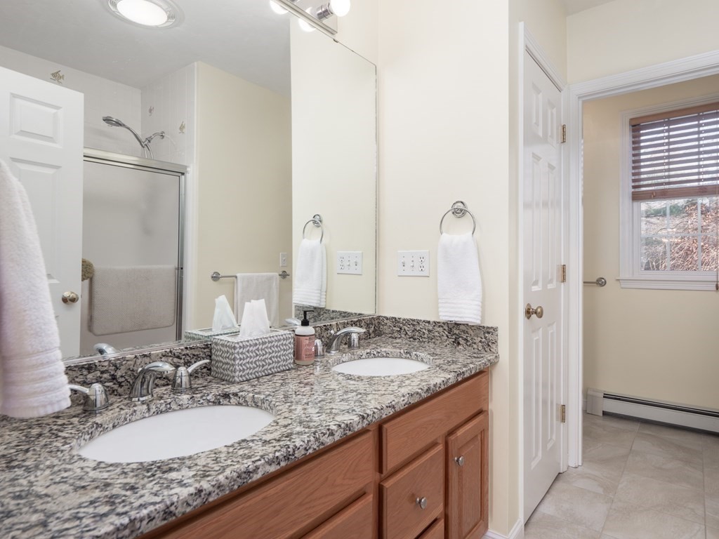 14 Talbott Farm Drive Mendon, MA 01756 - Photo 22 of 40 a bathroom with a granite countertop sink and a mirror