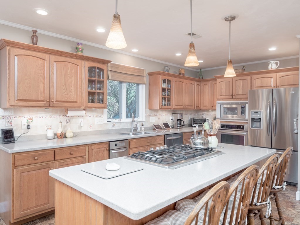 14 Talbott Farm Drive Mendon, MA 01756 - Photo 5 of 40 a kitchen with kitchen island a sink stove and refrigerator