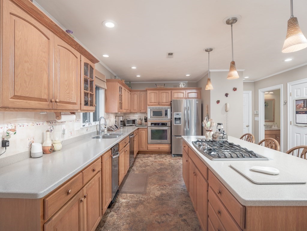 14 Talbott Farm Drive Mendon, MA 01756 - Photo 8 of 40 a kitchen with kitchen island granite countertop a sink and a stove
