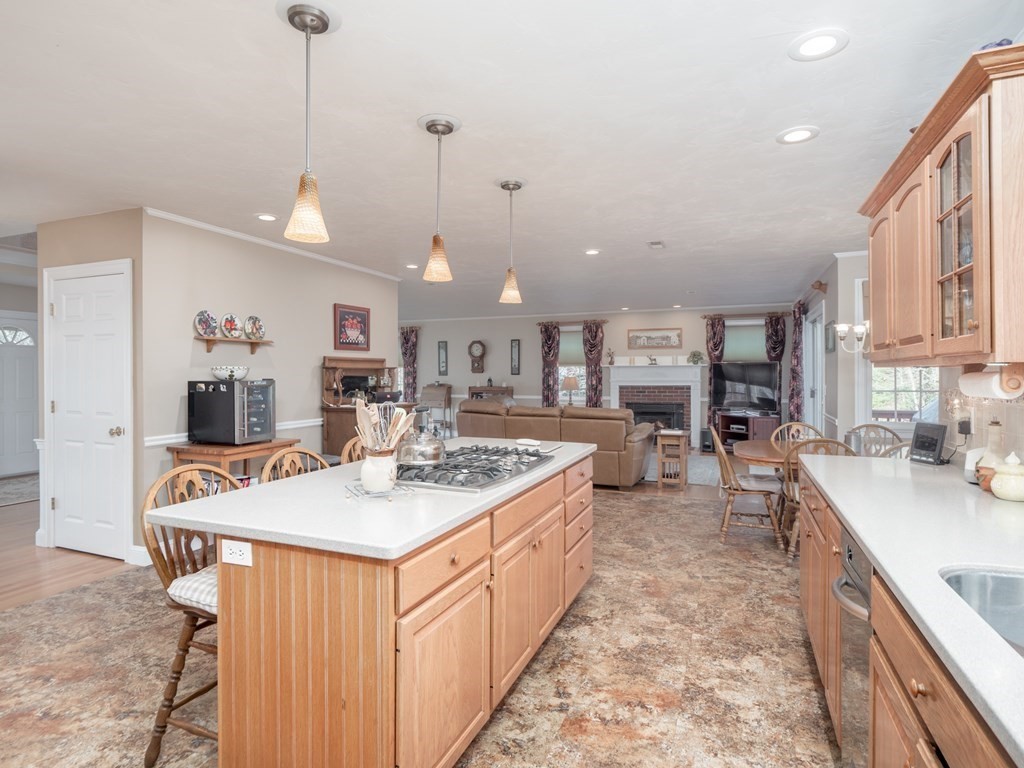 14 Talbott Farm Drive Mendon, MA 01756 - Photo 9 of 40 a large kitchen with kitchen island a stove a sink a center island and a wooden floor