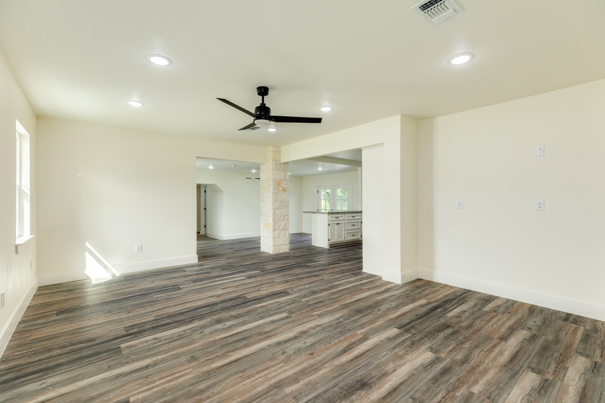 1200 Gifford Lane Angleton, TX 77515 - Photo 11 of 26 a view of an empty room with wooden floor and a window