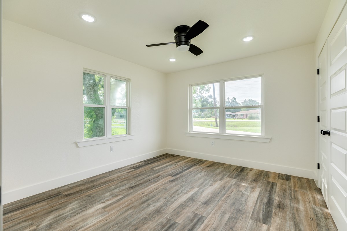 1200 Gifford Lane Angleton, TX 77515 - Photo 23 of 26 a view of an empty room with a window and wooden floor