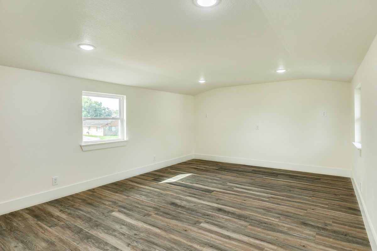 1200 Gifford Lane Angleton, TX 77515 - Photo 26 of 26 an empty room with wooden floor and windows