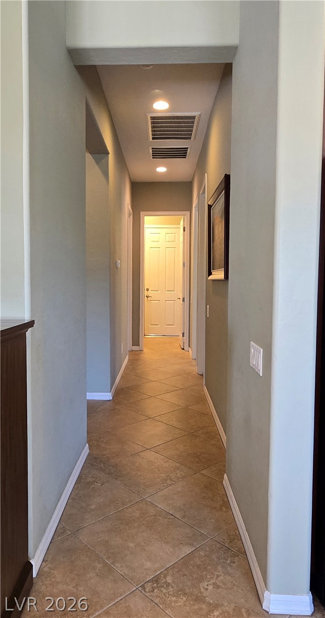 2567 Dirleton Place Henderson, NV 89044 - Photo 41 of 67 A well-lit corridor with recessed lighting guides visitors through the home's interior.