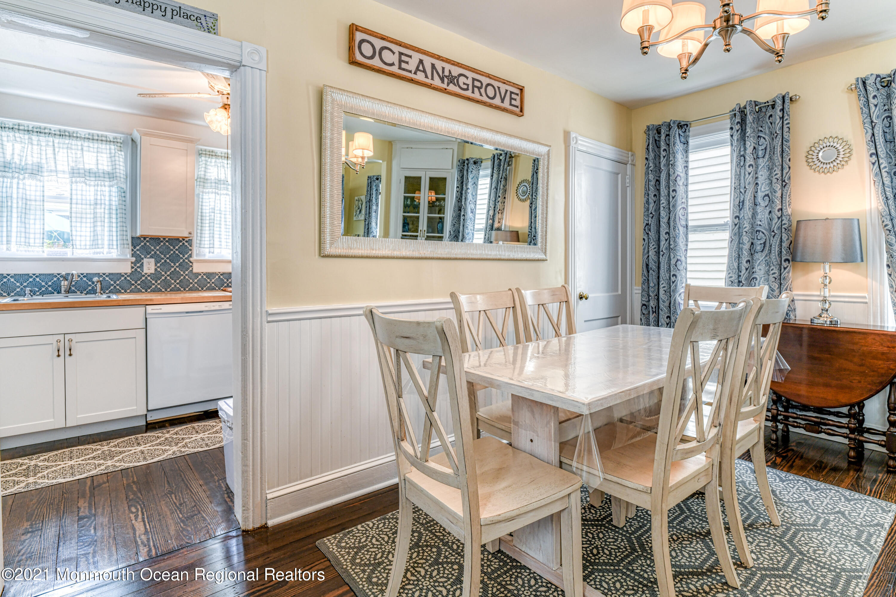 87 Embury Avenue Ocean Grove, NJ 07756 - Photo 11 of 55 a dining room with wooden floor and large windows