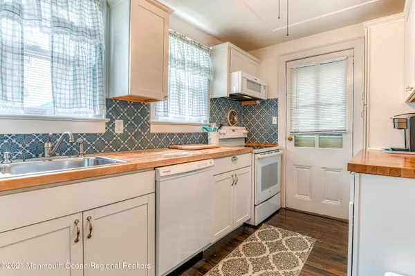 a kitchen that has a sink and a stove in it