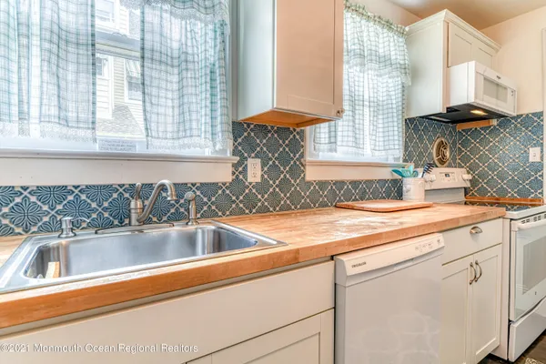 a view with a sink and dishwasher next to a window