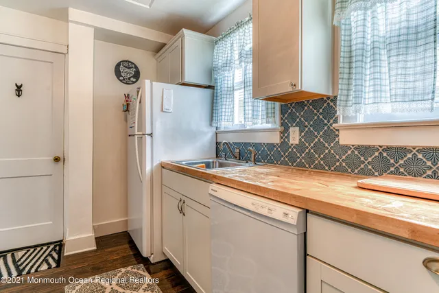 a room with a refrigerator and a window