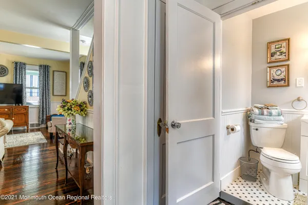 a bathroom with a toilet a sink and a mirror